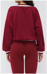 Back view of burgundy sports sweatshirt showing contrast striped cuffs and hem details