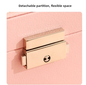 Close-up of pink lychee grain leather watch box with a secure gold metal buckle closure