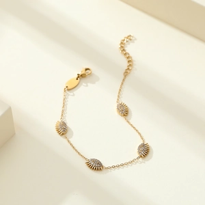 Elegant gold evil eye bracelet with cubic zirconia charms and adjustable lobster clasp