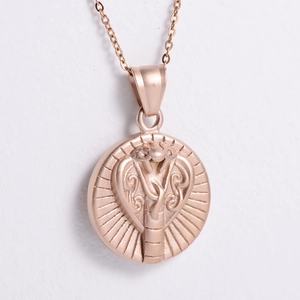Macro shot of rose gold cobra snake totem pendant with vintage metal texture and radial patterns