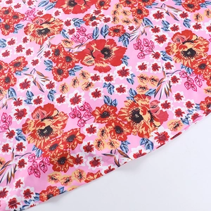 Detailed macro view of pink floral print fabric with high-quality single needle stitching
