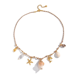 Detail of bohemian woven necklace featuring gold starfish, dolphin, shell, and pearl charms