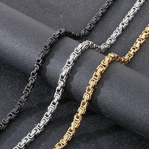 Detail of woven stainless steel king chains in black, silver, and gold finishes