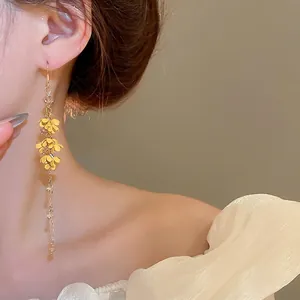 Elegant long tassel earrings with yellow flowers and golden beads for women