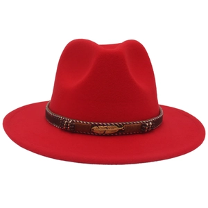 Detail of red wool fedora with brown ethnic band and golden feather metal accent