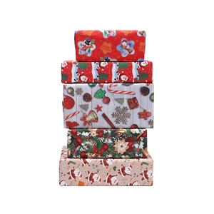 Five rolls of colorful Christmas wrapping paper with festive Santa and reindeer patterns