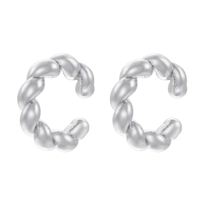 Macro detail of silver twisted C-shaped ear cuffs with high-quality metallic finish