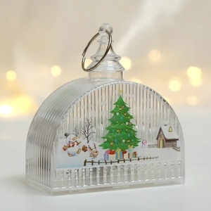 Detail of LED Christmas lantern with snowman and tree illustration on textured glass