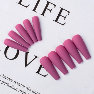 Detail view of purple matte ballerina press-on nails arranged on aesthetic white paper