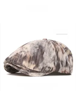 Detail of khaki vintage newsboy cap showing cotton fabric texture and sun-faded finish
