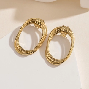 Macro detail of 14K gold plated stainless steel multi-layered oval hoop earrings
