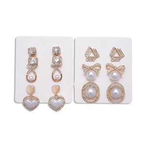 12-piece gold earring set with pearls and rhinestones featuring heart and bow designs