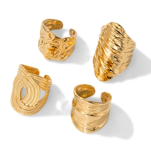 Set of four gold titanium steel rings with irregular hammered textures and open adjustable bands