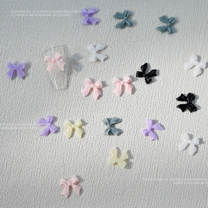 Colorful resin bow nail art accessories in multiple shades for professional manicure decoration