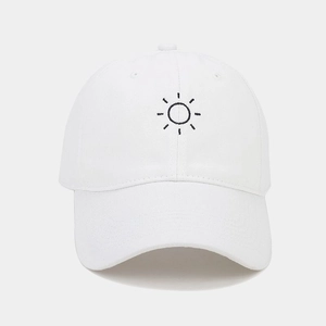 Detail of sun embroidery on the crown of a white cotton baseball cap for men and women