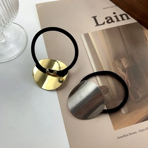 Minimalist gold and silver metal hair ties with high elasticity bands on magazine