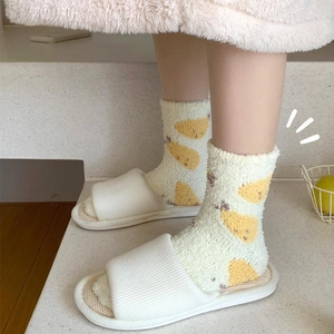 Warm coral fleece socks with yellow pear pattern worn with white home slippers