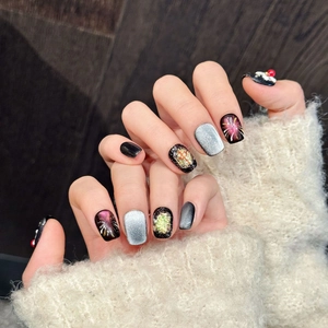 Sparkly black press-on nails with 3D red beads and fireworks nail art design