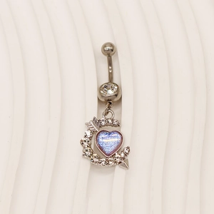 Close-up of heart navel ring with blue opal stone and shimmering crystal butterfly