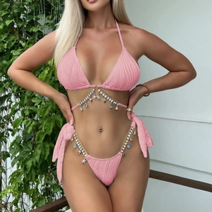 Detail of pink ribbed bikini with gold chains and ocean-themed starfish shell pendants