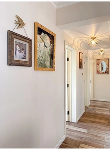 Detailed view of luxury golden flying bird wall decor in a vintage style corridor