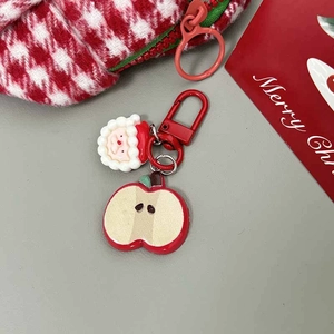 Detail of Christmas keychain with Santa Claus, apple charm and Merry Christmas card