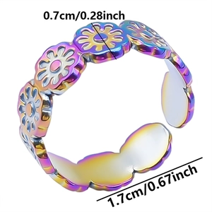Macro detail of rainbow stainless steel floral ring showing 0.7cm width dimensions