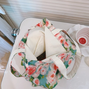 Macro detail of the floral tote bag showing its cotton lining and internal pocket