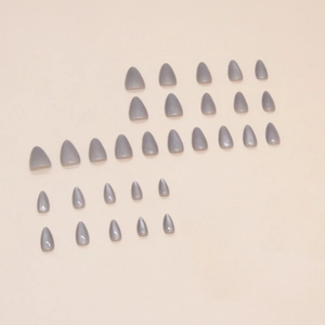 Gray-blue cat eye almond shaped press-on nails set with gradient sizes on pink background