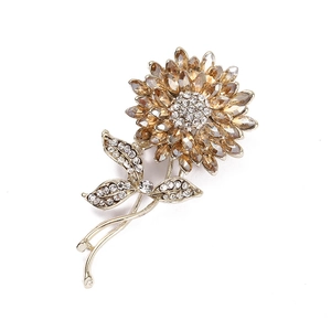 Luxurious flower brooch in gold with champagne crystals and sparkling diamond accents