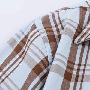 Detailed view of blue plaid poplin shirt featuring shoulder seams and fabric texture