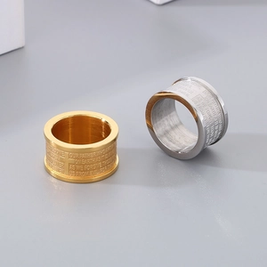 Macro detail of men's wide titanium steel ring with engraved Bible Lord's Prayer