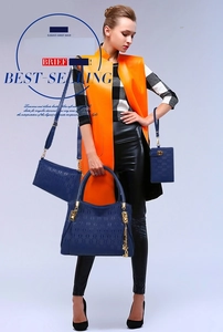 Three-piece dark blue embossed handbag set featuring tote, crossbody and pouch bags