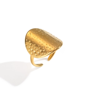 Detail of a gold open ring with a hammer-textured shield face and high-polish finish