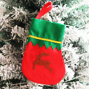 Mini red Christmas stocking with green trim and reindeer silhouette for festive tableware