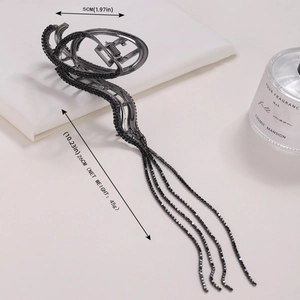 Detail of black metal hair claw clip with rhinestones and 26cm long tassel fringe