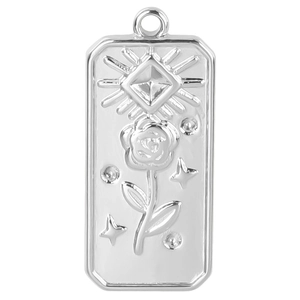 Macro view of silver stainless steel rectangular pendant with embossed rose and stars