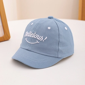Close-up of baby baseball cap featuring sky blue cotton fabric and smile embroidery