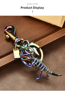Detailed macro view of colorful iridescent metal dinosaur skeleton keychain on leather