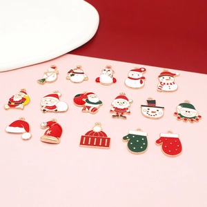 Detailed view of sixteen assorted Christmas enamel charms with snowman and Santa designs