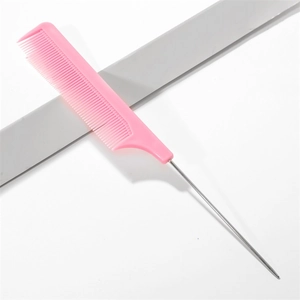 Detail of pink hair parting comb with plastic teeth and a fine metal needle tail