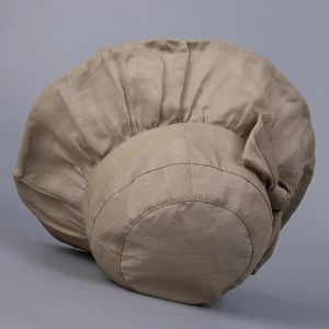 Detailed macro view of the ramie sun hat fabric texture and side bow decoration