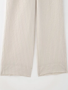 Close-up of beige vertical striped trousers with high-quality stitching and woven texture