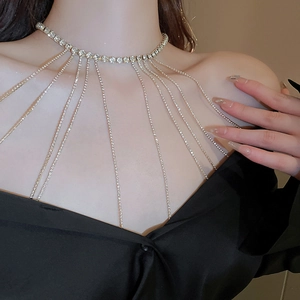 Close-up of sparkling rhinestone choker with long tassel fringe on a female model