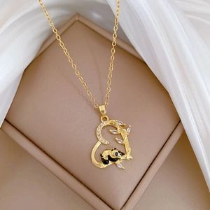 Detailed close-up of a luxury panda and bamboo heart pendant on a gold chain necklace
