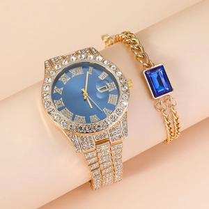 Elegant gold women's watch set with blue dial, roman numerals and matching crystal bracelet