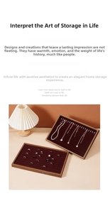 Detail of walnut wood jewelry trays with red velvet lining for rings and necklaces