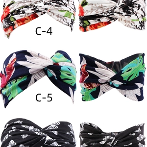 Detailed view of bohemian knot headbands with tropical leaf and butterfly prints