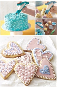 Close-up of manual cake airbrush kit coloring mousse cakes and heart-shaped cookies