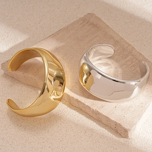 Minimalist wide C-shape open bangles in gold and silver finish with polished mirror surface